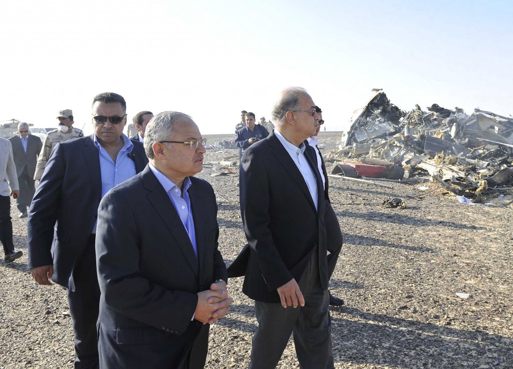 In this image released by the Prime Minister's office, Sherif Ismail, center, visits the site where a plane crashed in Hassana Egypt, Friday, Oct. 31, 2015. A Russian aircraft carrying 224 people, including 17 children, crashed Saturday in a remote mountainous region in the Sinai Peninsula about 20 minutes after taking off from a Red Sea resort popular with Russian tourists, the Egyptian government said. There were no survivors.(Suliman el-Oteify, Egypt Prime Minister's Office via AP)