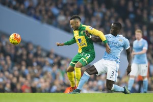 Manchester City's Bacary Sagna, right, fights for the ball against Nathan Redmond of Norwich City during the English Premier League soccer match between Manchester City and Norwich at the Etihad Stadium, Manchester, England, Saturday Oct. 31, 2015. (AP Photo/Jon Super)