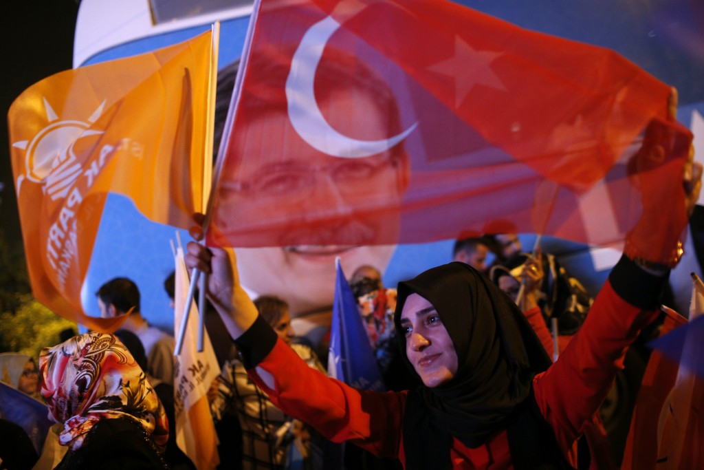 Supporters of Turkey's ruling Justice and Development Party celebrate over the election results in Istanbul,Turkey, late Sunday, June 7, 2015. With 99.9 percent of the vote counted, President Recep Tayyip Erdogan's AKP had the support of around 41 percent of voters, state-run TRT television said. (AP Photo/Emrah Gurel)