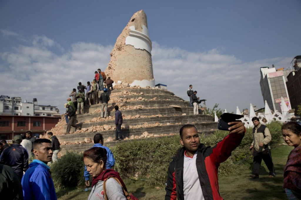 A man takes a selfie at the historic Dharahara Tower, a city landmark, that was damaged in Saturday’s earthquake in Kathmandu, Nepal, Monday, April 27, 2015. A strong magnitude earthquake shook Nepal’s capital and the densely populated Kathmandu valley on Saturday devastating the region and leaving tens of thousands shell-shocked and sleeping in streets. (AP Photo/Bernat Armangue)