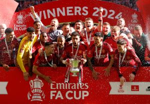 Soccer Football - FA Cup - Final - Manchester City v Manchester United - Wembley Stadium, London, Britain - May 25, 2024 Manchester United's Bruno Fernandes celebrates with the trophy and teammates after winning the FA Cup Action Images via Reuters/Andrew Couldridge     TPX IMAGES OF THE DAY