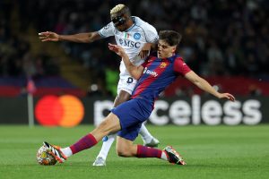 Barcelona's Spanish defender #33 Pau Cubarsi (R) and Napoli's Nigerian forward #09 Victor Osimhen vie for the ball during the UEFA Champions League last 16 second leg football match between FC Barcelona and SSC Napoli at the Estadi Olimpic Lluis Companys in Barcelona on March 12, 2024. (Photo by LLUIS GENE / AFP) (Photo by LLUIS GENE/AFP via Getty Images)