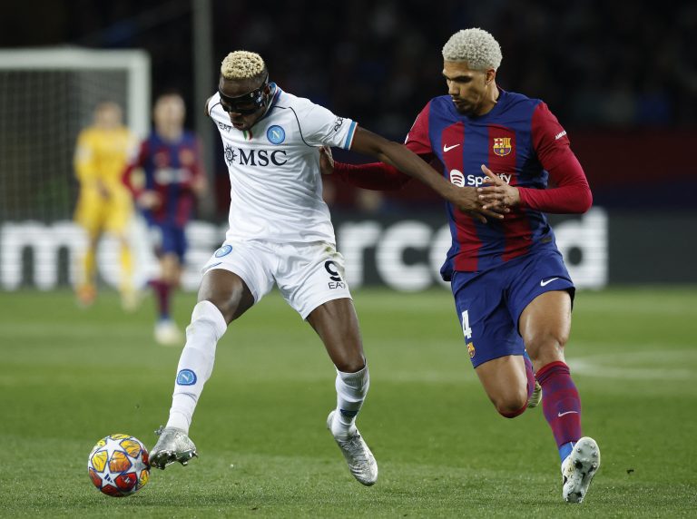 Soccer Football - Champions League - Round of 16 - Second Leg - FC Barcelona v Napoli - Estadi Olimpic Lluis Companys, Barcelona, Spain - March 12, 2024 Napoli's Victor Osimhen in action with FC Barcelona's Ronald Araujo REUTERS/Albert Gea