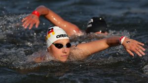 PARIS, FRANCE - AUGUST 08: Leonie Beck of Team Germany competes in the Marathon Swimming Women's 10k on day thirteen of the Olympic Games Paris 2024 at Pont Alexandre III on August 08, 2024 in Paris, France. (Photo by Sarah Stier/Getty Images)