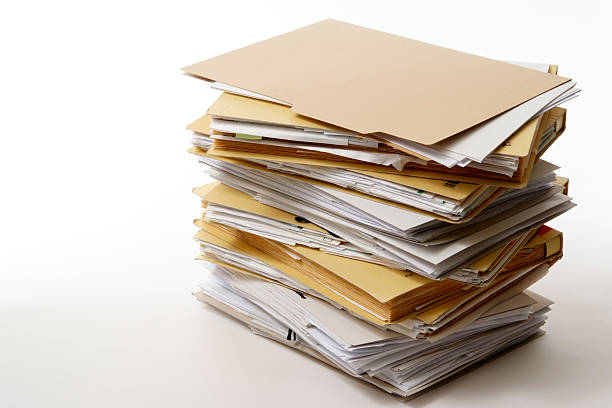 Stacked brown file folders isolated on white with soft shadow.