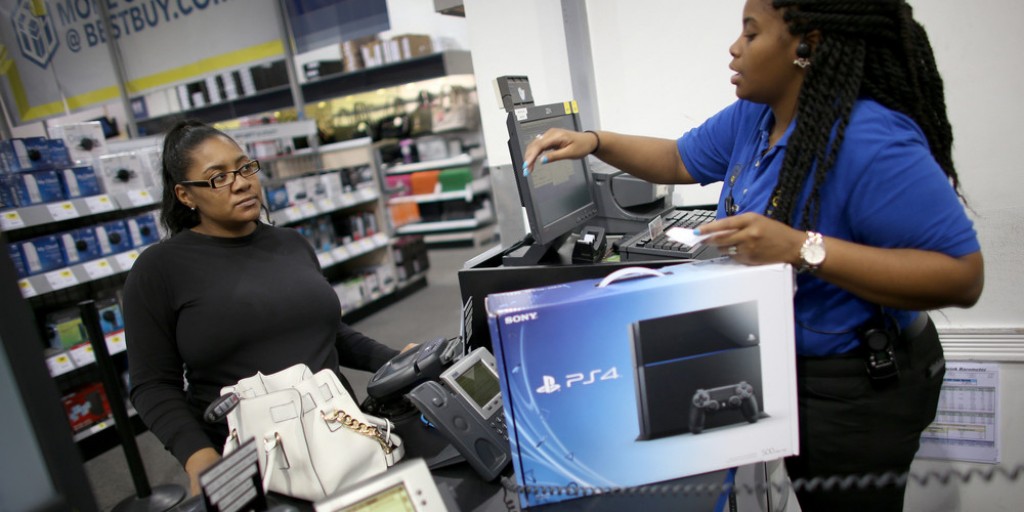 PEMBROKE PINES, FL - NOVEMBER 15:  Kimberly Lee (L) purchases a Sony Playstation 4 from Ashley Delva a sales associate at Best Buy after they went on sale at midnight on November 15, 2013 in Pembroke Pines, Florida. PlayStation 4 is the follow-up to the company's PlayStation 3 and is priced at $400.  (Photo by Joe Raedle/Getty Images)