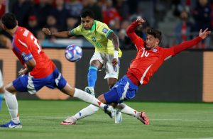 Soccer Football - World Cup - South American Qualifiers - Chile v Brazil - Estadio Nacional, Santiago, Chile - October 10, 2024 Chile's Felipe Loyola in action with Brazil's Rodrygo REUTERS/Ivan Alvarado